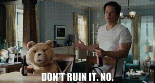 A Man Is Standing Next To A Teddy Bear That Says Do N't Ruin It . No . GIF