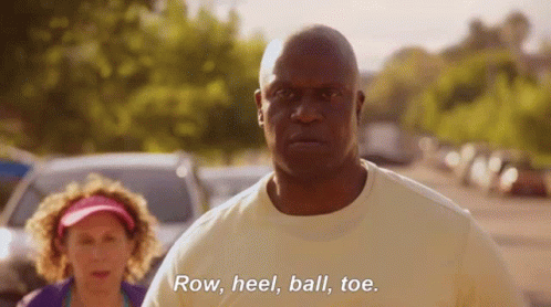 A Man Is Standing Next To A Woman And Saying Row , Heel , Ball , Toe GIF
