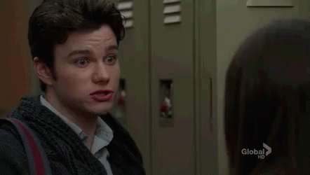 A Man Is Standing Next To A Woman In A Locker Room And Making A Funny Face . GIF