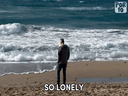 A Man Is Standing On A Beach With The Words So Lonely Behind Him GIF