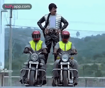 A Man Is Standing On A Motorcycle Next To Two Other Men Riding Motorcycles . GIF