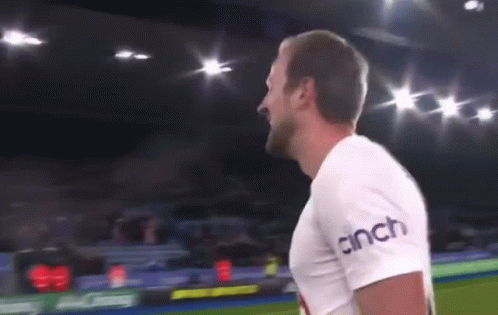 A Man Is Standing On A Soccer Field Wearing A Cinch T-Shirt . GIF