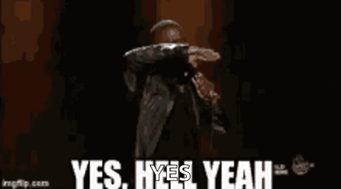 A Man Is Standing On A Stage Holding A Microphone And Saying Yes , Yes , Yeah . GIF