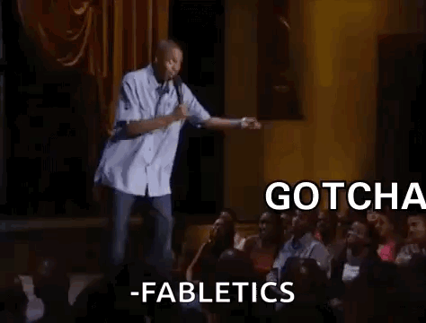 A Man Is Standing On A Stage In Front Of A Crowd Of People . GIF