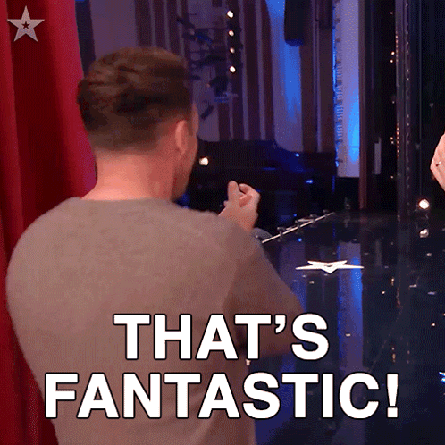 A Man Is Standing On A Stage With The Words That 'S Fantastic Behind Him GIF