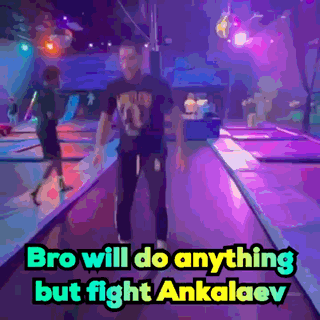 A Man Is Standing On A Trampoline With The Words Bro Will Do Anything But Fight Ankalaev Above Him GIF
