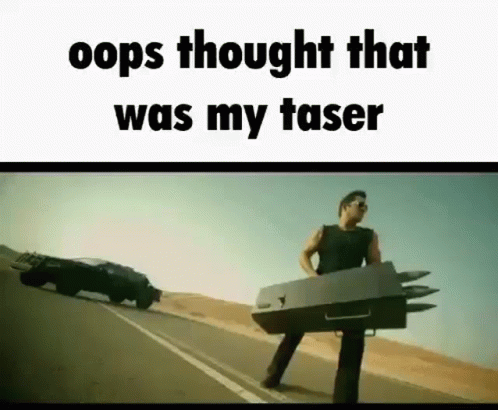 A Man Is Standing On The Side Of A Road Holding A Box That Looks Like A Car . GIF