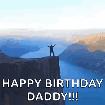 A Man Is Standing On Top Of A Cliff Overlooking A Body Of Water . GIF