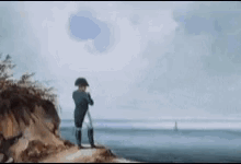 A Man Is Standing On Top Of A Cliff Overlooking The Ocean Looking Through Binoculars . GIF