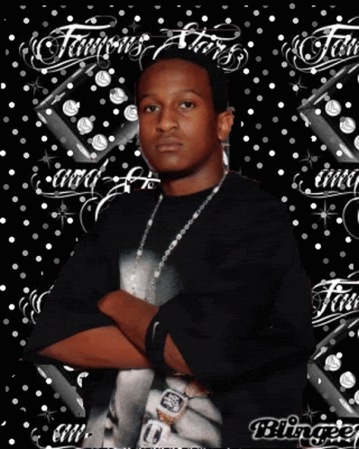 A Man Is Standing With His Arms Crossed In Front Of A Background That Says Famous Stars GIF