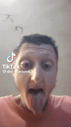 A Man Is Sticking His Tongue Out In A Tik Tok Video Taken By Daniellarson62 GIF