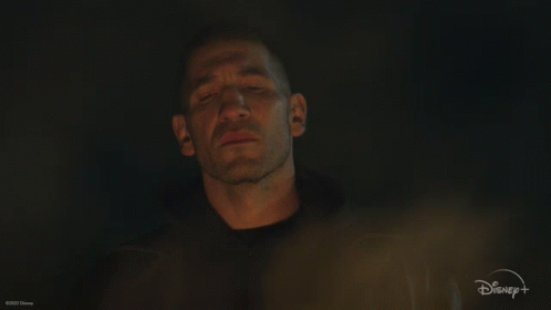 A Man Is Surrounded By Flames With A Disney Logo In The Background GIF