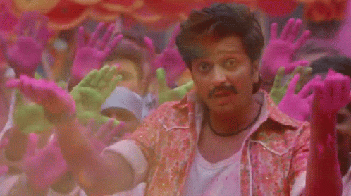 A Man Is Surrounded By Pink And Green Hands GIF