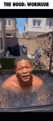 A Man Is Swimming In A Tub Of Water With The Caption " The Hood Wormsur " GIF