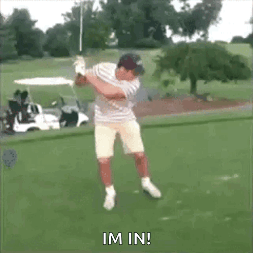 A Man Is Swinging A Golf Club On A Golf Course And The Words Im In Are Visible GIF