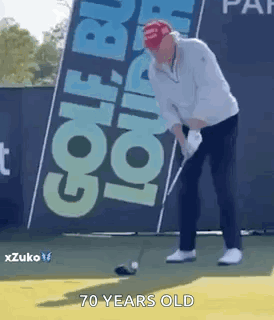 A Man Is Swinging A Golf Club On A Golf Course In Front Of A Sign That Says Golf . GIF