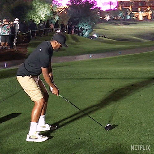 A Man Is Swinging A Golf Club On A Golf Course With Netflix Written On The Bottom GIF