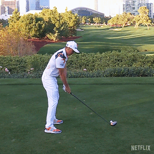A Man Is Swinging A Golf Club On A Golf Course With Netflix Written On The Bottom GIF