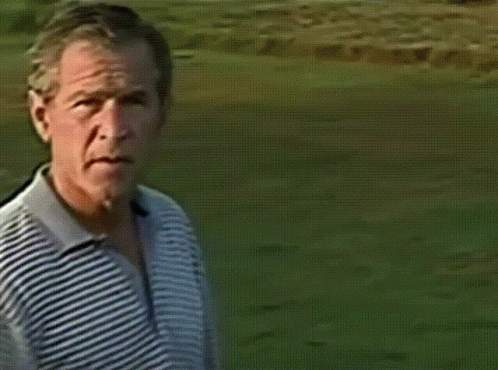 A Man Is Swinging A Golf Club On A Green GIF