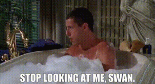 A Man Is Taking A Bath In A Bathtub Filled With Foam And Bubbles . GIF