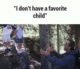 A Man Is Taking A Picture Of A Child In A Forest . GIF