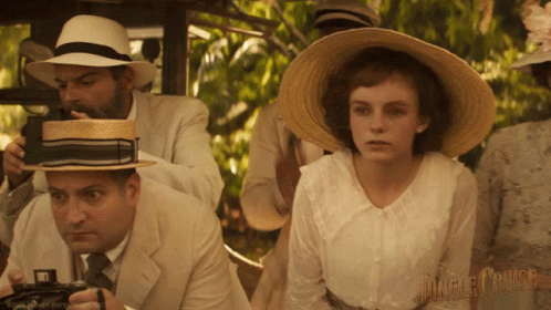 A Man Is Taking A Picture Of A Woman In A Jungle Cruise Movie GIF