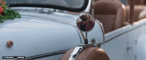A Man Is Taking A Picture Of Himself In A Car Mirror GIF