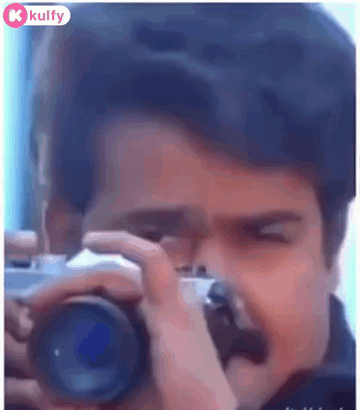 A Man Is Taking A Picture Of Himself With A Camera . GIF