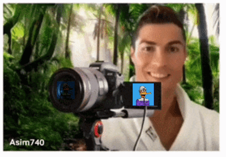 A Man Is Taking A Picture Of Himself With A Camera With A Picture Of A Cartoon Character On The Screen GIF