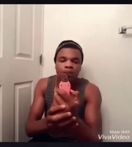 A Man Is Taking A Picture Of Himself With A Cell Phone . GIF