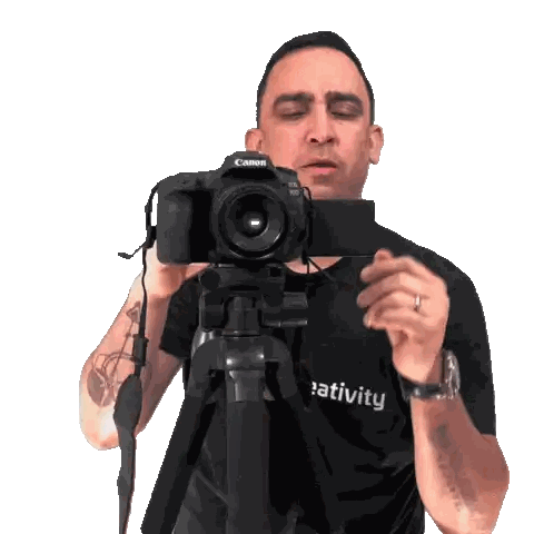 a man is taking a picture with a canon camera on a tripod