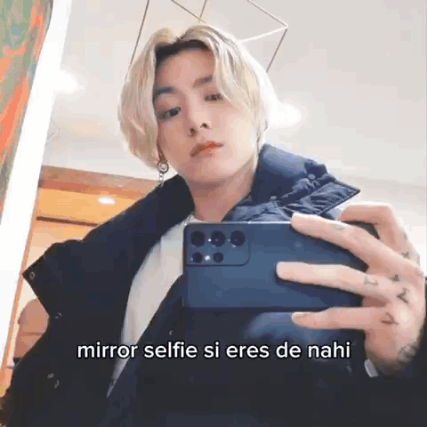 A Man Is Taking A Selfie In Front Of A Mirror With A Caption . GIF