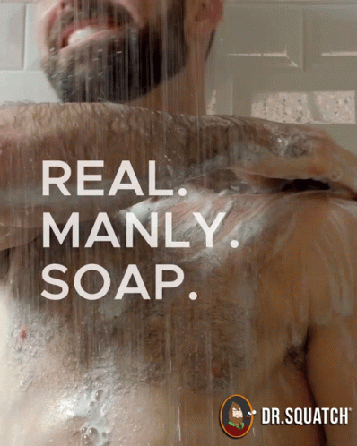 A Man Is Taking A Shower With The Words Real Manly Soap GIF