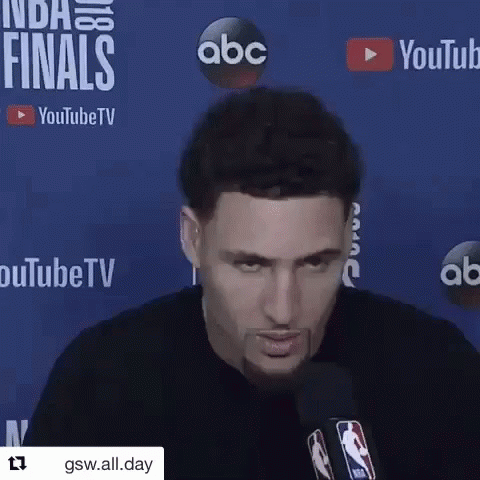 A Man Is Talking Into A Microphone In Front Of A Blue Background That Says Youtube Tv . GIF