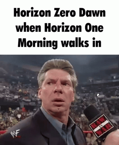 A Man Is Talking Into A Microphone In Front Of A Crowd . GIF