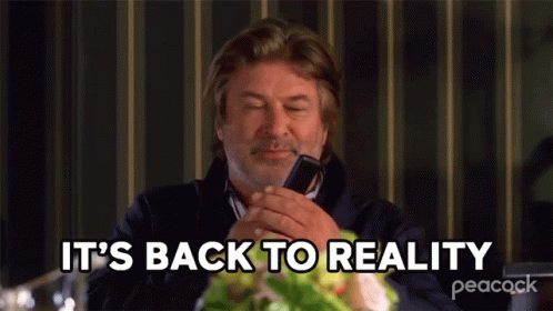 A Man Is Talking On A Cell Phone And The Words It 'S Back To Reality Are Above Him GIF