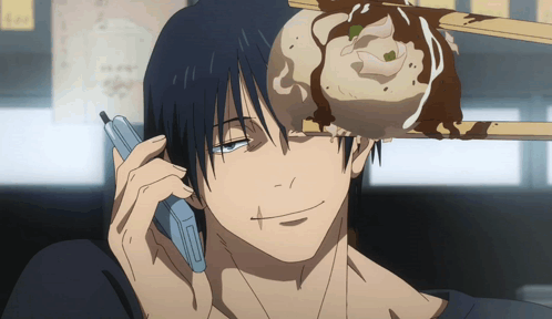 A Man Is Talking On A Cell Phone While A Dumpling Is On His Head GIF