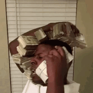 A Man Is Talking On A Cell Phone While Carrying A Stack Of Money On His Head . GIF