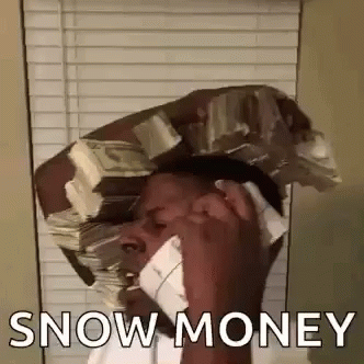 A Man Is Talking On A Cell Phone While Holding A Stack Of Money On His Head . GIF