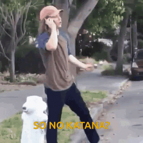 A Man Is Talking On A Cell Phone While Standing Next To A White Fire Hydrant . GIF