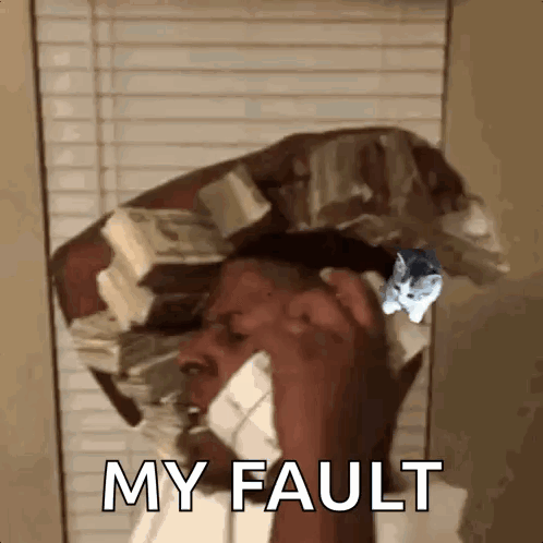 A Man Is Talking On A Cell Phone With A Cat On His Head . GIF