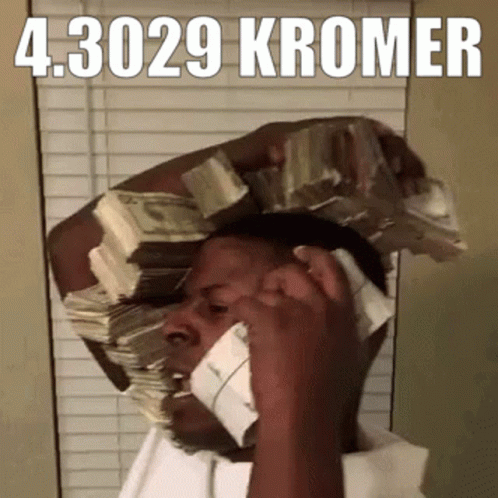 A Man Is Talking On A Cell Phone With A Stack Of Money On His Head GIF