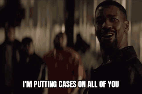 A Man Is Talking On A Phone And Says " I 'M Putting Cases On All Of You " GIF
