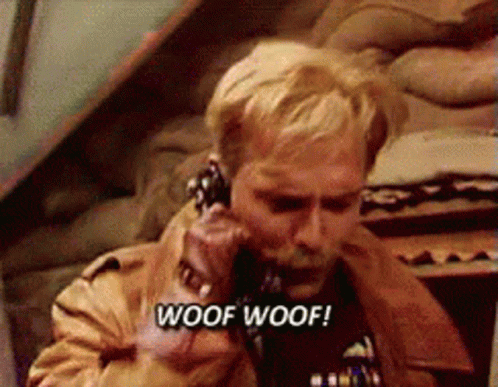A Man Is Talking On A Phone With The Words Woof Woof Written On The Bottom GIF