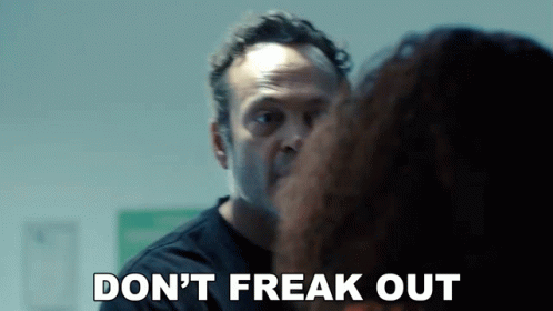 A Man Is Talking To A Woman And Says Do N't Freak Out . GIF
