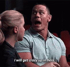 A Man Is Talking To A Woman In A Movie Theater And Saying `` I Will Get Crazy Up In Here '' . GIF