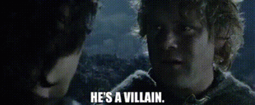 A Man Is Talking To Another Man And Says `` He 'S A Villain '' . GIF