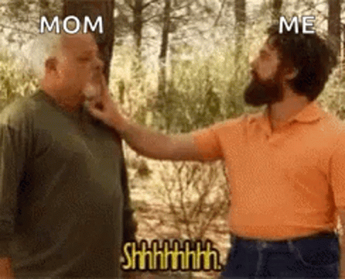 A Man Is Touching Another Man 'S Face In The Woods . GIF