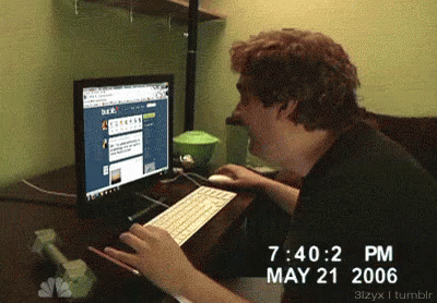 A Man Is Typing On A Keyboard In Front Of A Computer Screen Which Says May 21 2006 GIF