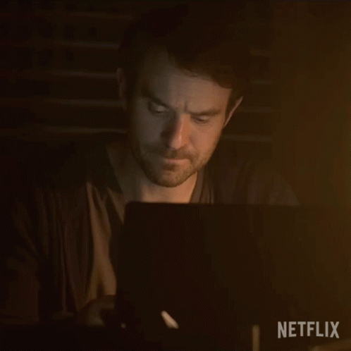 Man Using Laptop In Dark Room GIF